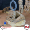 Painted 3D print of an ancient Egyptian ruin with a celestial star portal ring, hieroglyphs, and a statue of the god Horus, set on a desert wargaming mat.