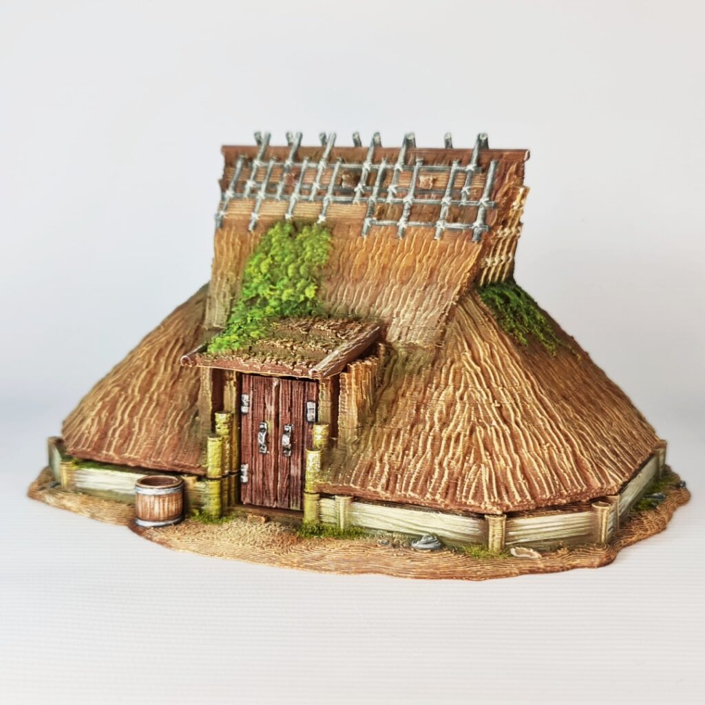 Defend your village with the Kabuto-Minka, a "samurai helmet" style farmhouse scaled for 28mm. This support-free FDM model features a dramatic, low-sweeping thatched roof and protective timber detailing—perfect for recreating the silk-farming mountain retreats and noble rural estates of feudal Japan.