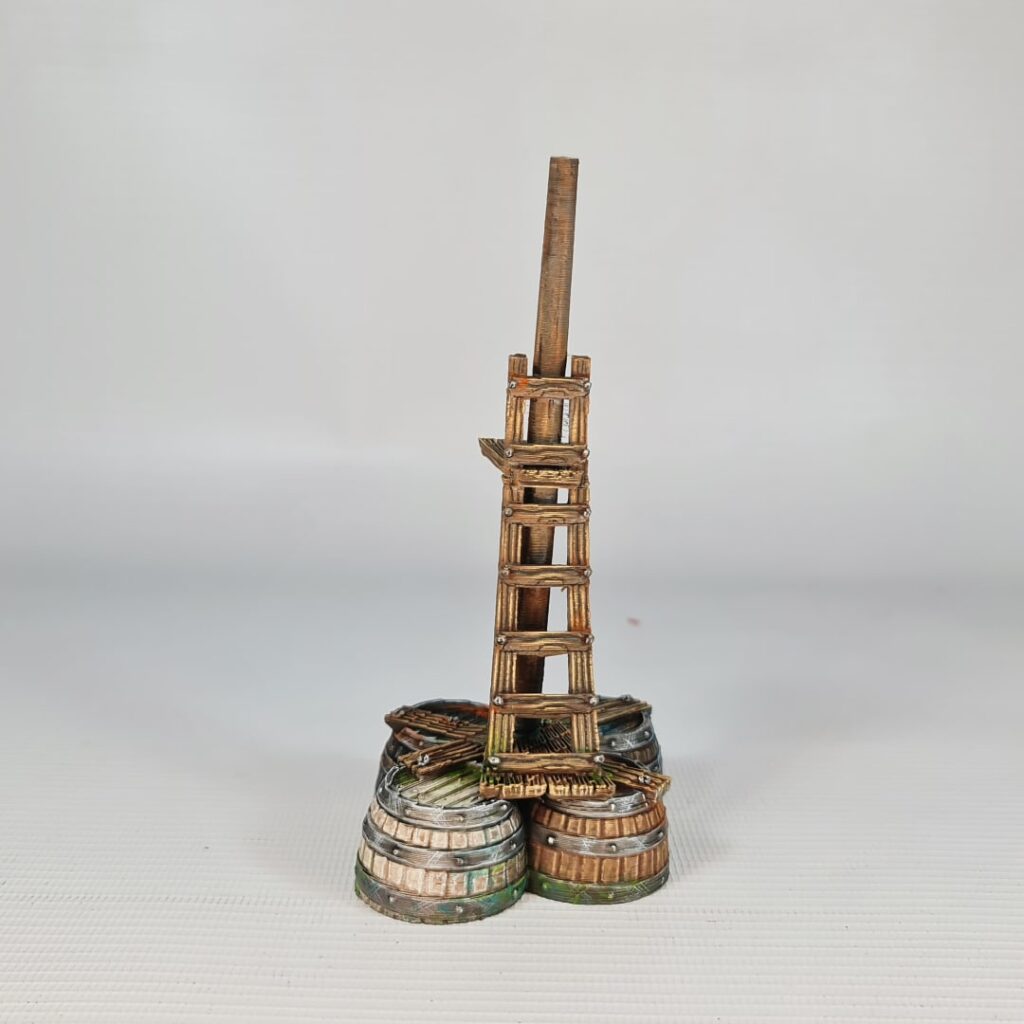 A 3D printed and painted model of a tall wooden ladder on a platform supported by three barrels. The terrain piece is painted with realistic wood and metal textures, suitable for 28mm tabletop wargaming.